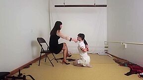 Train A Obedient Slave :: Brunette Domina Whips Kneeling Nurse In Black Dress